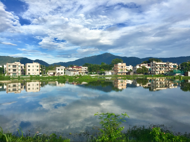 Hong Kong apartments near a small body of water pic