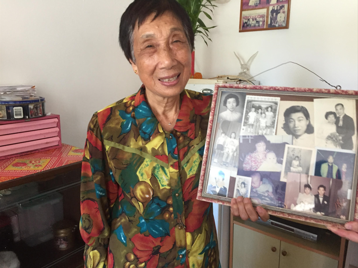 Hong Kong resident holding a board with photos pic