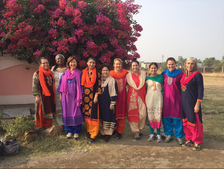 Christina with several women dress in India attire pic