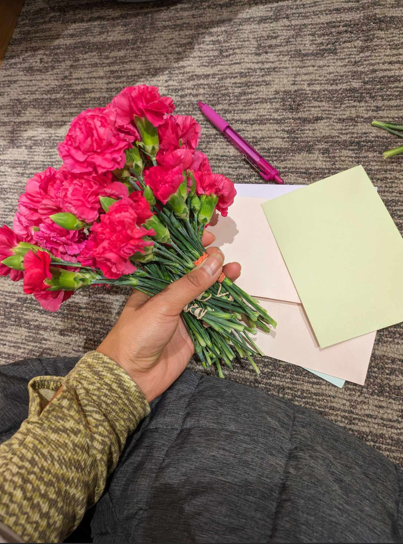 Christina holding pink roses and notes on the side